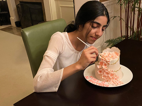 Sonali works on a nature cake